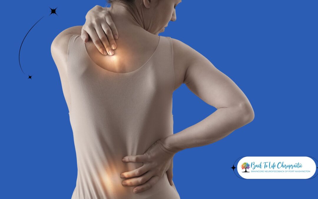 Patient speaking with a chiropractor in a clinical setting, reviewing spine models and treatment plans.
